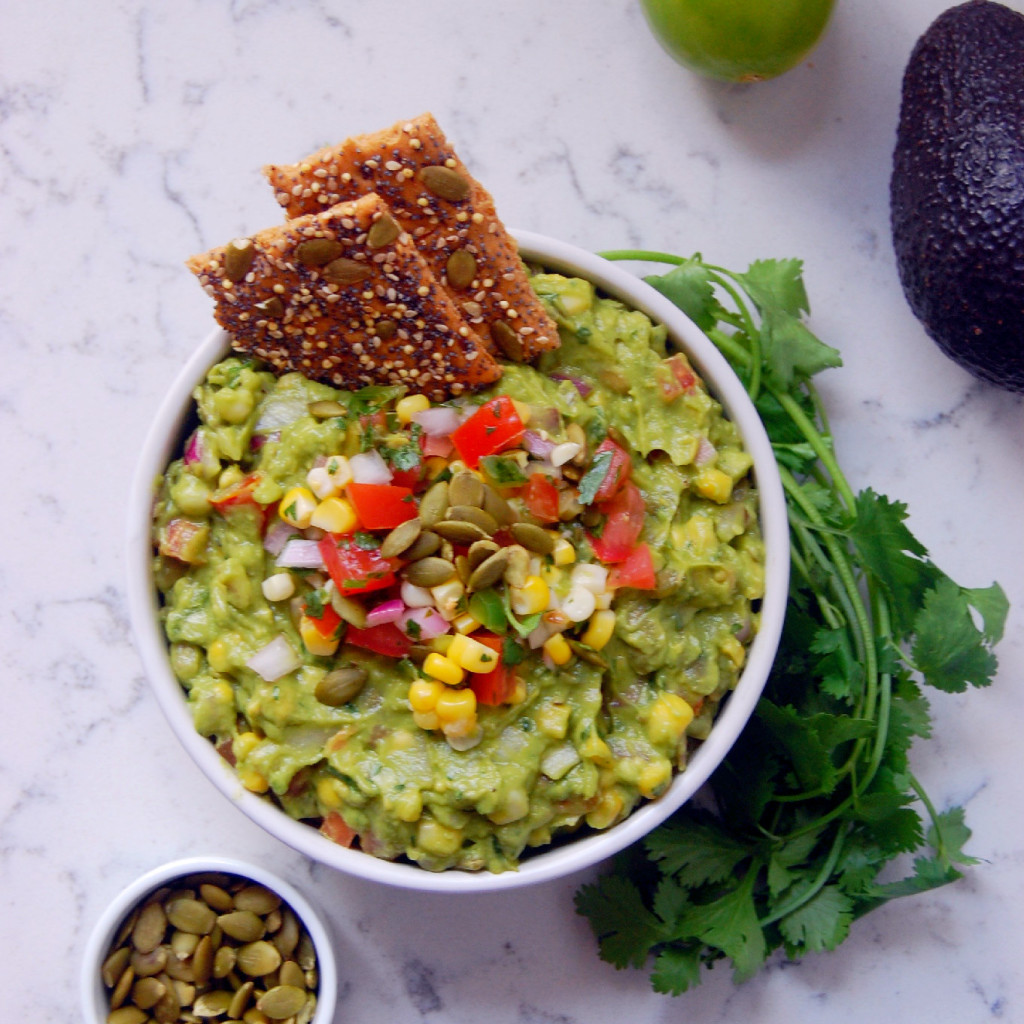 If you love corn salsa, you're going to love this Chunky Sweet Corn Guacamole with Pepitas! The pumpkin seeds add a bit of crunch to the guacamole recipe #glutenfree #vegan | uprootkitchen.com