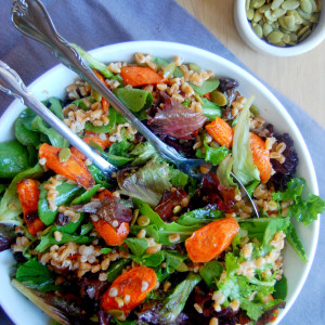 Cinnamon Roasted Carrot and Farro Salad, topped with raisins and pumpkin seeds. The perfect fall vegetarian dish! | uprootfromoregon.com