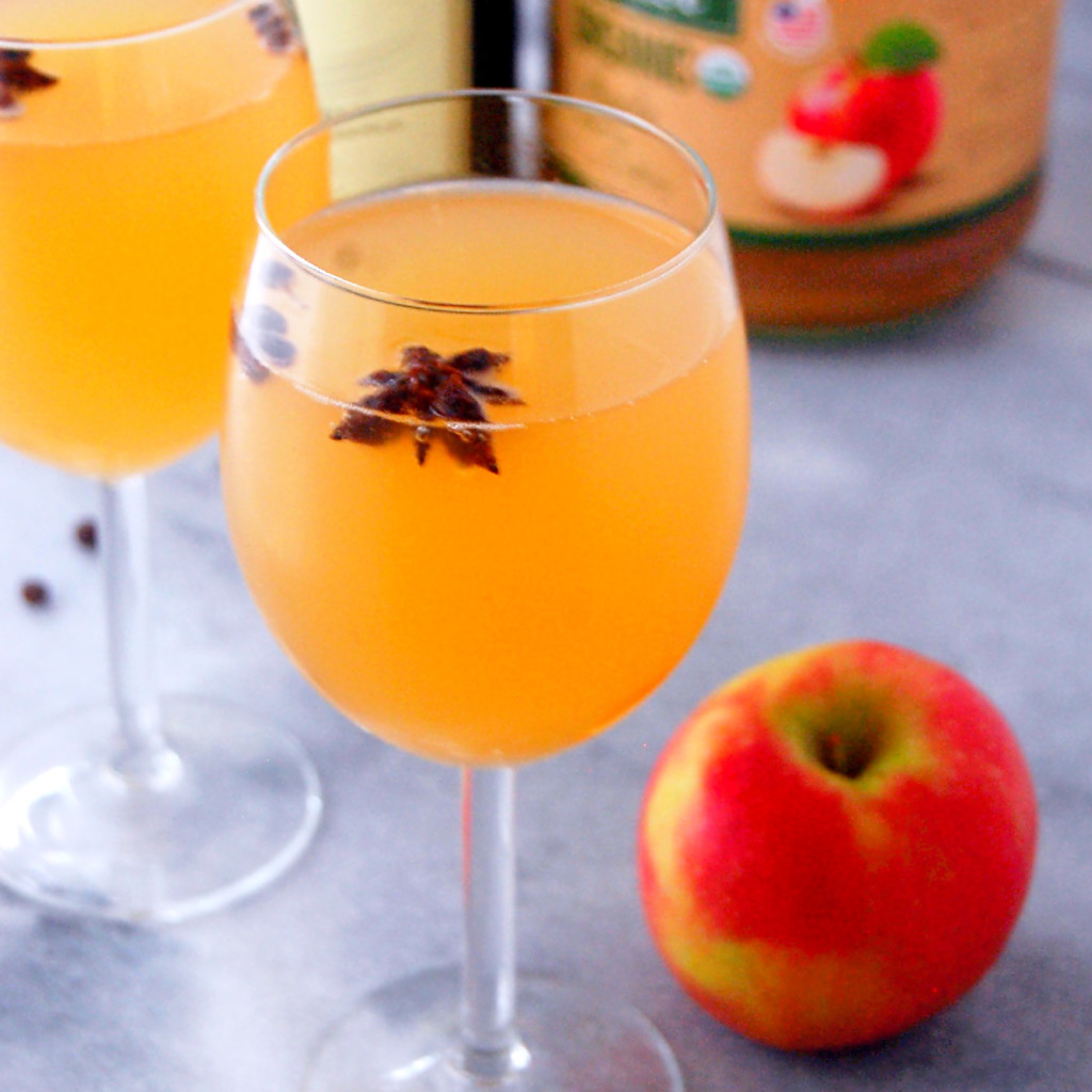 Spiced Apple Cider Mimosas with star anise pods and allspice berries, a simple way to make a quick winter cocktail more festive! | uprootfromoregon.com
