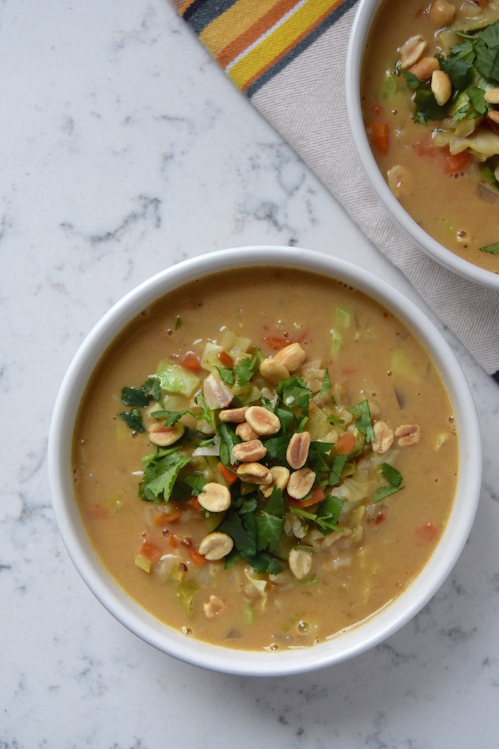 This African Peanut and Vegetable Soup is made by combining a rich vegetable broth with a variety of vegetables, filling brown rice, and rich peanut butter. | uprootkitchen.com