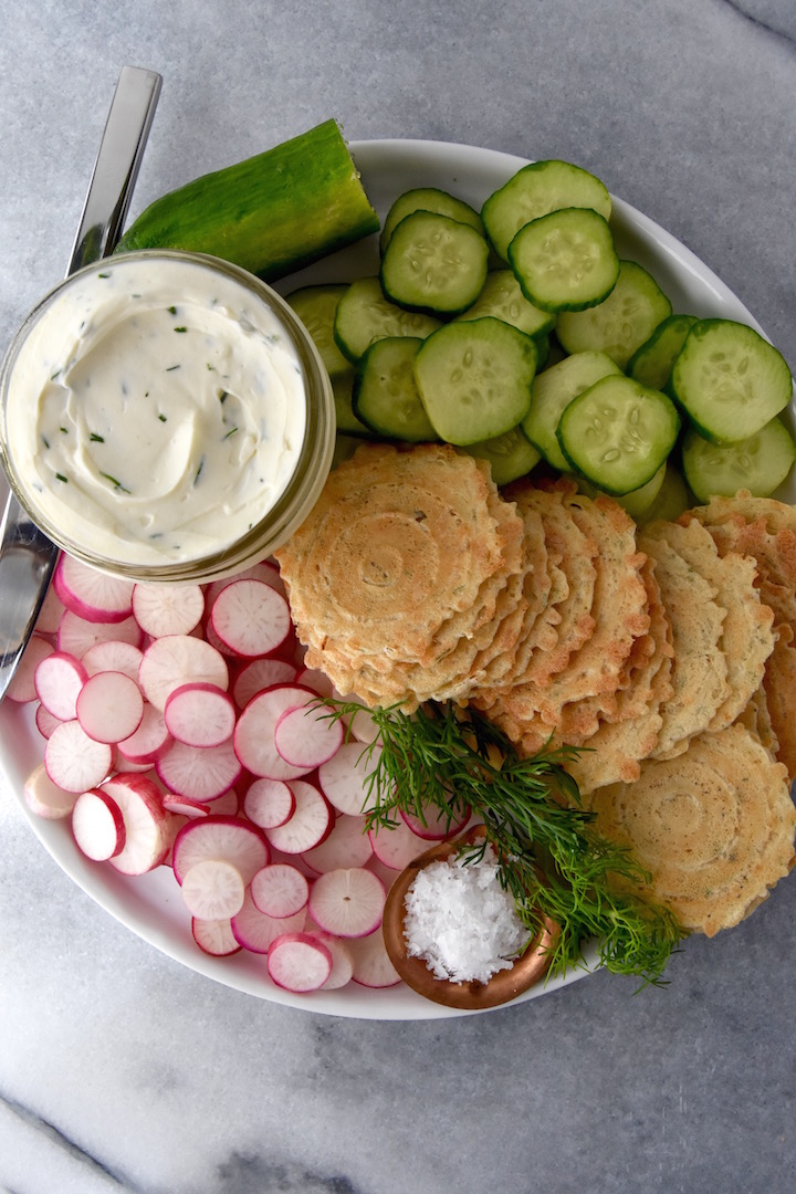 This simple combination of whipped dill cream cheese, crisps, fresh summer vegetables and flaky salt is a wonderful snack plate idea for summer. | uprootkitchen.com