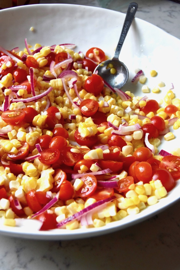 Marinating sweet corn, tomatoes and red onion